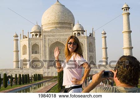 Stock Photo - India, Agra, Tourist Man Taking A Photo Of Tourist Woman In Front Of The Taj Mahal.. Fotosearch