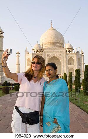 India, Agra, Tourist Woman Taking Photo Of Herself With A Hindu Woman In Front Of The Taj Mahal. View Large Photo Image Stock Image - India, Agra, Tourist Woman Taking Photo Of Herself With A Hindu Woman In Front Of The Taj Mahal.. Fotosearch