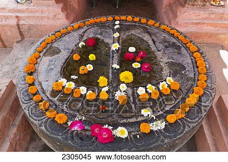 Stock Photography - India, Bihar, Feet of Buddha covered with flowers outside Mahabodhi Temple; Bodhgaya. Fotosearch