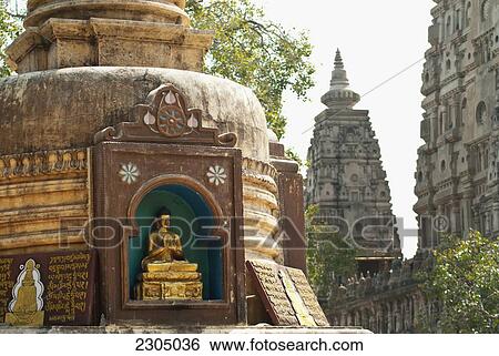 Stock Photograph - India, Bihar, Stupa with small Buddha beside Mahabodhi Temple; Bodhgaya. Fotosearch