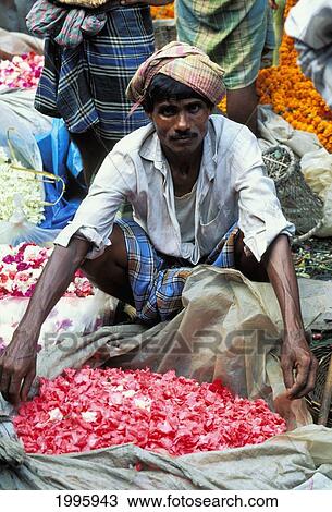 Stock Image - India, Calcutta, Local Street Vendor Selling Flower Petals No Model Release. Fotosearch