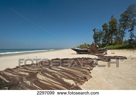 India, Fishermen sorting out their nets on beach; Goa View Large Photo Image Stock Photo - India, Fishermen sorting out their nets on beach; Goa. Fotosearch