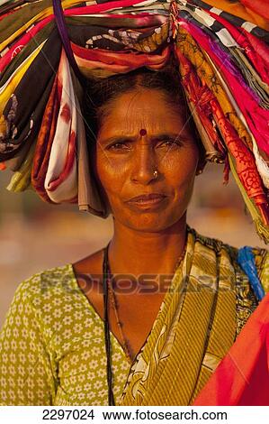 Picture - India, Goa, Woman selling cloth at dusk; Candolim. Fotosearch