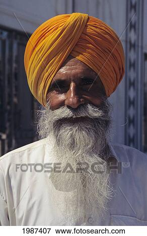Stock Photo - India, Gwalior, Portrait Of Sikh Holy Man With Long White Beard, Wearing Orange Turban And White Shirt.. Fotosearch