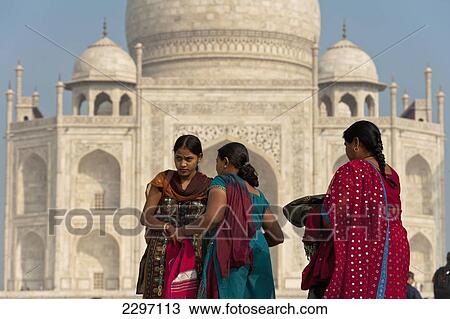Stock Image - India, Indian tourists in front of Taj Mahal; Agra. Fotosearch