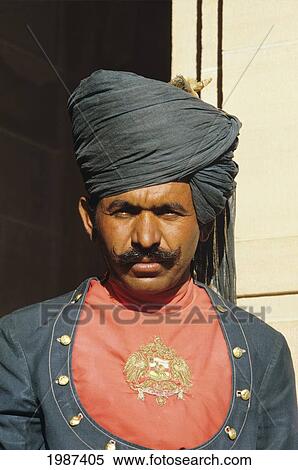 Stock Photography - India, Jodhpur, Portrait Of Palace Guard, Young Man With Green Outfit And Turban.. Fotosearch