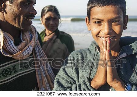 Stock Photo - India, Karnataka, Gokarna, Indian Boy Smiling And Greeting; Gokarna Beach. Fotosearch