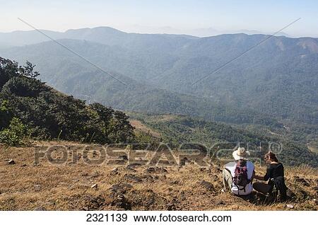 Stock Photo - India, Karnataka, Looking At View; Gokarna, Two Tourists Resting. Fotosearch