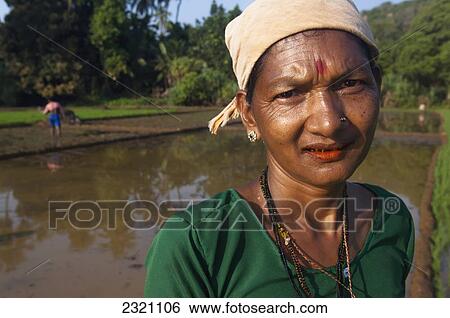 Stock Photograph - India, Karnataka, Portrait Of Female Worker In Paddy Fields; Gokarna. Fotosearch