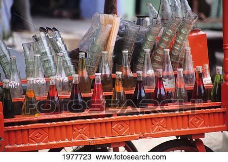Stock Image - India, Local Drink Cart With Many Different Colored Drink In Glass Bottles.. Fotosearch