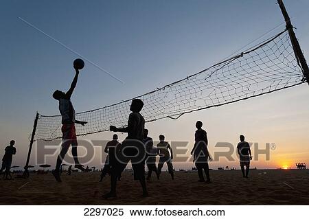 India, Men playing beach volleyball at dusk; Goa View Large Photo Image Stock Photography - India, Men playing beach volleyball at dusk; Goa. Fotosearch