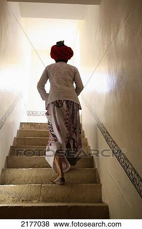 Stock Photo - India, Person in staircase of Rawla Narlai Hotel; Rajasthan. Fotosearch