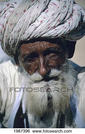 Stock Photograph - India, Rajasthan, Headshot Of Senior Village Man With White Beard And Turban.. Fotosearch