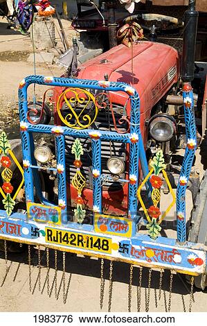 Stock Photograph - India, Rajasthan, Jaipur, Crazy Colors Of Transportation Tractor That Carries People.. Fotosearch