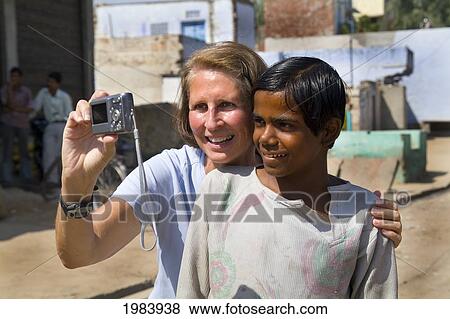 India, Rajasthan, Jaipur, Female Tourist Taking Picture Of Self With A Young Local Boy. View Large Photo Image Stock Photo - India, Rajasthan, Jaipur, Female Tourist Taking Picture Of Self With A Young Local Boy.. Fotosearch