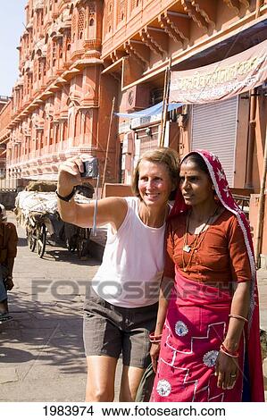 Picture - India, Rajasthan, Jaipur, Tourist Woman Taking Photo Of Herself With Hindu Woman In Front Of The Wind Palace.. Fotosearch