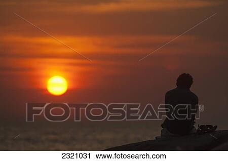 Stock Image - India, Watching The Sunset On Palolem Beach; Goa. Fotosearch