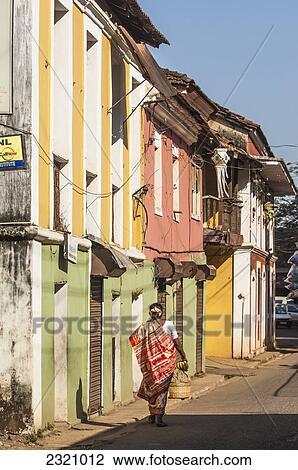 Stock Image - India, Woman Walking On Street; Goa. Fotosearch