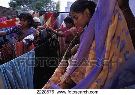 Stock Photograph - India, Young Women Hanging Saris Out To Dry; Nagalapuram. Fotosearch