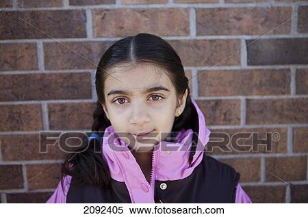 Indian Girl Against Brick Wall Of An Esl School; Guelph Ontario Canada View Large Photo Image Stock Photography - Indian Girl Against Brick Wall Of An Esl School; Guelph Ontario Canada. Fotosearch