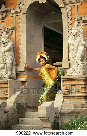Stock Image - Indonesia, Bali, Legong Dancer Poses In Entranceway B1760. Fotosearch