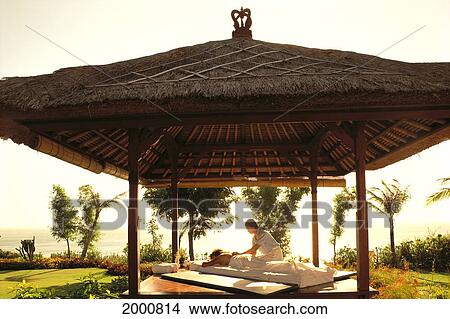 Indonesia, Bali, Ritz Carlton, View Of Person Receiving Outdoor Massage View Large Photo Image Picture - Indonesia, Bali, Ritz Carlton, View Of Person Receiving Outdoor Massage. Fotosearch