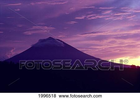 Stock Photo - Indonesia, Bali, Sacred Mt. Aguna At Sunrise, Dramatic Skies, Silhouette Mountain A62E. Fotosearch
