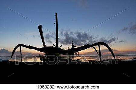 Stock Image - Indonesia, Bali, Sanur Beach, Outrigger Boat On Beach. Fotosearch