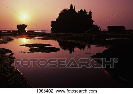 Stock Image - Indonesia, Bali, Tanah Lot Temple At Sunset, Reflections In Water.. Fotosearch