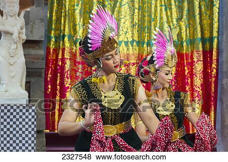 Stock Photo - Indonesia, Bali, Two women Legong dancers performing at annual Bali Arts Festival in Denpasar. Running for month of July festival is a top showcase for both Balanese and other Indonesian dance troupes; Denpasar. Fotosearch