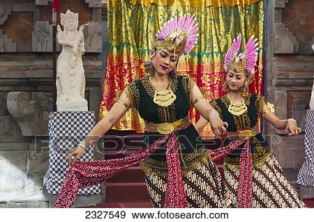 Indonesia, Bali, Two women Legong dancers performing at annual Bali Arts Festival in Denpasar. Running for month of July festival is top showcase for both Balanese and other Indonesian dance troupes; Denpasar View Large Photo Image Stock Photo - Indonesia, Bali, Two women Legong dancers performing at annual Bali Arts Festival in Denpasar. Running for month of July festival is top showcase for both Balanese and other Indonesian dance troupes; Denpasar. Fotosearch