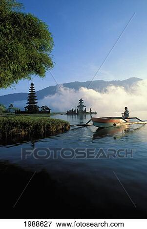 Indonesia, Bali, Ulu Danu Temple At Sunrise, Canoe Paddling On Water No Model Release View Large Photo Image Stock Photo - Indonesia, Bali, Ulu Danu Temple At Sunrise, Canoe Paddling On Water No Model Release. Fotosearch