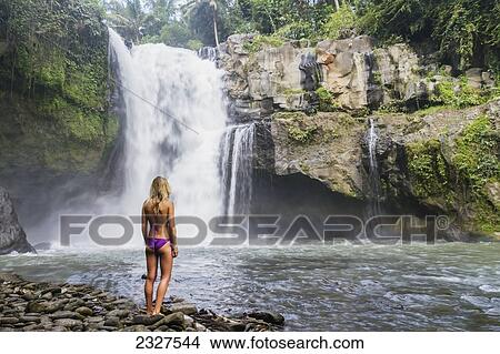Picture - Indonesia, Bali, Young girl in bikini next to Tegenungan Waterfall; Ubud. Fotosearch