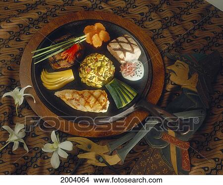 Picture - Indonesia, Fish, Beef, And Vegetables Arranged On Plate Wooden Puppet On Table Next To Plate, Tablecloth. Fotosearch