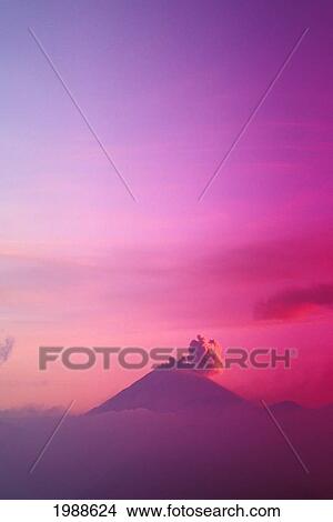 Picture - Indonesia, Java, Bromo Tengger Semeru National Park, Smoky Active Volcano, Misty Sunset Sky. Fotosearch