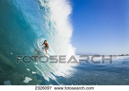 Stock Photo - Indonesia, Sumbawa, Professional Surfer Chris Ward In The Tube Of A Wave. Editorial Use Only.. Fotosearch