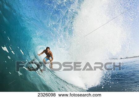 Stock Photo - Indonesia, Sumbawa, Professional Surfer Chris Ward In The Tube Of A Wave. Editorial Use Only.. Fotosearch