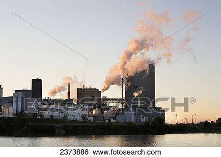 Stock Photograph - Industrial Building With Billowing Smoke By Wabigoon Lake; Dryden, Ontario, Canada. Fotosearch