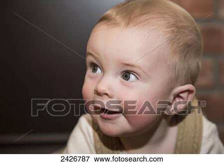 Infant crawling on floor and smiling; St. Albert, Alberta, Canada View Large Photo Image Stock Photo - Infant crawling on floor and smiling; St. Albert, Alberta, Canada. Fotosearch