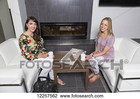Stock Image - Interior designer and design consultant selecting tiles in showroom of tile store; Edmonton, Alberta, Canada. Fotosearch