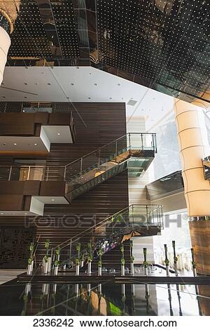 Stock Image - Interior Of A Building With Glass Railings On A Staircase And Shiny Tiled Floors; Beijing, China. Fotosearch