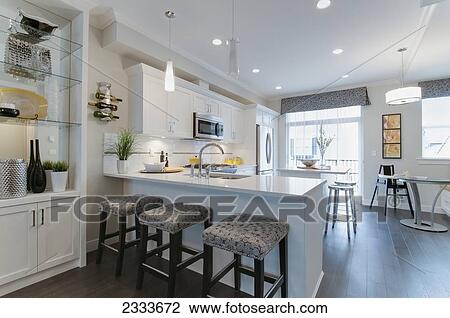 Stock Image - Interior Of Modern Kitchen With Breakfast Bar; Surrey, British Columbia, Canada. Fotosearch