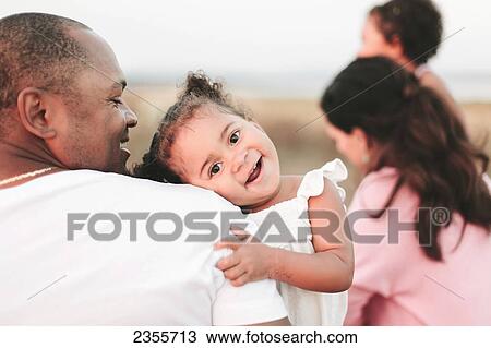 Interracial Family Relaxing On Beach; British Columbia, Canada View Large Photo Image Stock Image - Interracial Family Relaxing On Beach; British Columbia, Canada. Fotosearch