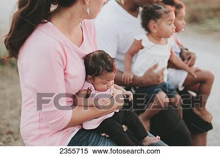 Stock Photography - Interracial Family Relaxing On Beach; British Columbia, Canada. Fotosearch
