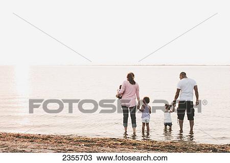 Interracial Family Wading In Water By Beach; British Columbia, Canada View Large Photo Image Stock Image - Interracial Family Wading In Water By Beach; British Columbia, Canada. Fotosearch