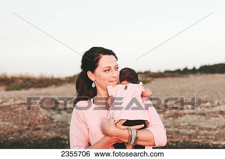 Stock Photograph - Interracial Mother And Baby Daughter On The Beach; British Columbia, Canada. Fotosearch