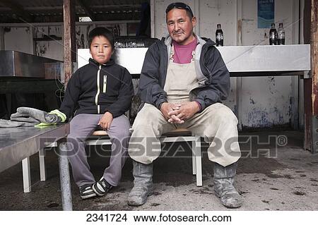 Picture - Inuit Father And Son In Their Workshop; Kangaamiut, Greenland. Fotosearch