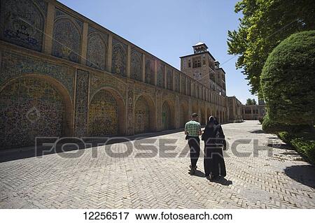 Iranian couple walking towards The Edifice of the Sun (Shams ol Emareh), Golestan Palace; Tehran, Iran View Large Photo Image Stock Photo - Iranian couple walking towards The Edifice of the Sun (Shams ol Emareh), Golestan Palace; Tehran, Iran. Fotosearch