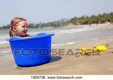 Isla Reynolds aged 4 plays with buckets and spades on Patnum beach, Goa, India. View Large Photo Image Stock Photograph - Isla Reynolds aged 4 plays with buckets and spades on Patnum beach, Goa, India.. Fotosearch