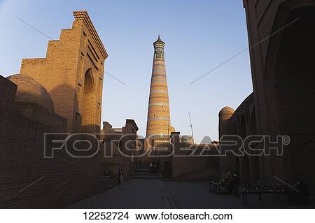 Picture - Islam Khoja minaret and Pakhlavan Mahmoud Mausoleum (left), inside Ichan Kala Old City; Khiva, Khwarezm, Uzbekistan. Fotosearch